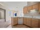 Corner view of kitchen with a breakfast bar that opens to a dining room with a chandelier at 701 Aztec Cir, Mesquite, NV 89027