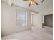 Bright living area featuring vaulted ceilings, neutral carpet and walls, and natural light at 701 Aztec Cir, Mesquite, NV 89027