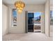 Bright living room with modern chandelier, carpet, and outdoor access at 701 Aztec Cir, Mesquite, NV 89027