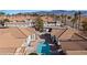 Community pool surrounded by well-maintained homes with terracotta roofs and palm trees at 701 Aztec Cir, Mesquite, NV 89027