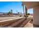 Neighborhood with mature palms, desert landscaping, and mountain views at 701 Aztec Cir, Mesquite, NV 89027