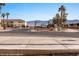 View of neighborhood street with mountain views and desert landscaping at 701 Aztec Cir, Mesquite, NV 89027