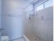 Updated bathroom featuring a tile shower, grab bar, and showerhead at 7117 Shadow Crest Dr, Las Vegas, NV 89119