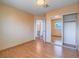 Bedroom with attached bath, mirror closet doors and hardwood floors at 7117 Shadow Crest Dr, Las Vegas, NV 89119