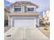 Two-story home featuring an attached two-car garage and desert landscaping at 7117 Shadow Crest Dr, Las Vegas, NV 89119