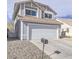 Exterior elevation view of a two-story home with a two car garage and desert landscaping at 7117 Shadow Crest Dr, Las Vegas, NV 89119