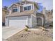 Two-story home with a desert xeriscape yard, a two-car garage and light gray paint at 7117 Shadow Crest Dr, Las Vegas, NV 89119