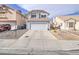 Two-story home with an attached two-car garage and desert landscaping at 7117 Shadow Crest Dr, Las Vegas, NV 89119