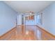 Spacious living room with hardwood floors, a ceiling fan and an adjacent kitchen area at 7117 Shadow Crest Dr, Las Vegas, NV 89119