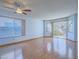 Bright living room with hardwood floors, a ceiling fan and sliding glass doors to the backyard at 7117 Shadow Crest Dr, Las Vegas, NV 89119