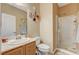 Bathroom featuring a single sink vanity, toilet and glass enclosed shower at 7433 Calzado Dr, Las Vegas, NV 89178