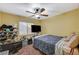 View of a bedroom with yellow walls, carpeted floor, shelving, and window at 7433 Calzado Dr, Las Vegas, NV 89178