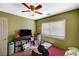 View of a bedroom with green walls, carpeted floor, shelving, and window at 7433 Calzado Dr, Las Vegas, NV 89178