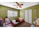 View of a bedroom with green walls, carpeted floor, closet, and window at 7433 Calzado Dr, Las Vegas, NV 89178