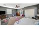 View of bedroom featuring neutral carpet, gray walls, white trim, and a ceiling fan at 7433 Calzado Dr, Las Vegas, NV 89178