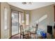 Dining area features a glass table, wood flooring, and sliding glass doors at 7433 Calzado Dr, Las Vegas, NV 89178