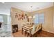 Bright dining room with stylish lighting and hardwood floors, adjacent to the living area at 7433 Calzado Dr, Las Vegas, NV 89178