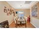 Dining room with chandelier lighting, hardwood floors, and bright natural light at 7433 Calzado Dr, Las Vegas, NV 89178