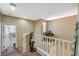 Hallway with carpeted floors and tan walls, leading to other rooms in the house at 7433 Calzado Dr, Las Vegas, NV 89178