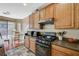 Kitchen area featuring an island, granite countertops, wooden cabinets and stainless appliances at 7433 Calzado Dr, Las Vegas, NV 89178