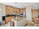 Kitchen area featuring an island, tile flooring, wooden cabinets and stainless appliances at 7433 Calzado Dr, Las Vegas, NV 89178