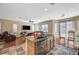 Open concept living room and kitchen with granite countertops, and tile flooring at 7433 Calzado Dr, Las Vegas, NV 89178