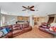 Open living area with hardwood floors, kitchen view and dining area, with a ceiling fan at 7433 Calzado Dr, Las Vegas, NV 89178