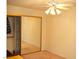 Bedroom with mirrored closet doors and ceiling fan at 7950 W Flamingo Rd # 1139, Las Vegas, NV 89147