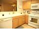 Kitchen area showcasing white appliances, light wood cabinets, and ample counter space at 7950 W Flamingo Rd # 1139, Las Vegas, NV 89147