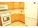 View of kitchen including white refrigerator, oven and light colored cabinets at 7950 W Flamingo Rd # 1139, Las Vegas, NV 89147