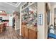 Stylish bar area with custom cabinetry, granite countertop, and display shelving for glasses and barware at 8404 Bay Crest Dr, Las Vegas, NV 89128