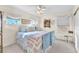 Bright bedroom featuring natural light, a ceiling fan, and a comfortable bed with blue accents at 8404 Bay Crest Dr, Las Vegas, NV 89128