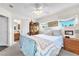 Well-lit bedroom with a ceiling fan, a bed, and a view into the attached bathroom at 8404 Bay Crest Dr, Las Vegas, NV 89128