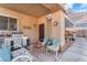 Outdoor kitchen under the shaded patio with a comfortable sitting area at 8404 Bay Crest Dr, Las Vegas, NV 89128