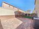 Backyard featuring a brick patio, landscaping and an AC unit at 8452 Viansa Loma Ave, Las Vegas, NV 89149