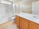 Clean bathroom featuring a shower-tub combo, tile flooring, and a modern vanity at 8452 Viansa Loma Ave, Las Vegas, NV 89149