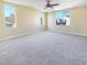 Spacious bedroom with plush carpeting and bright natural light from multiple windows at 8452 Viansa Loma Ave, Las Vegas, NV 89149