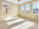 Bright bedroom featuring neutral carpet and multiple windows at 8452 Viansa Loma Ave, Las Vegas, NV 89149