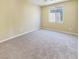 Cozy bedroom featuring neutral carpeting and a bright window at 8452 Viansa Loma Ave, Las Vegas, NV 89149