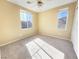 Well-lit bedroom with neutral walls, carpet, and bright windows at 8452 Viansa Loma Ave, Las Vegas, NV 89149