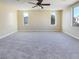 Large bedroom featuring neutral carpet, plenty of natural light, and a ceiling fan at 8452 Viansa Loma Ave, Las Vegas, NV 89149