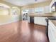 Bright kitchen featuring white cabinets, modern appliances, and wood-style flooring at 8452 Viansa Loma Ave, Las Vegas, NV 89149