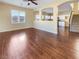 Elegant living room featuring wood floors and seamless access to the kitchen and staircase at 8452 Viansa Loma Ave, Las Vegas, NV 89149