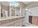 Well-lit bathroom with dual sinks, granite countertop, and a glass-enclosed shower at 10708 Clear Meadows Dr, Las Vegas, NV 89134