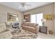 Cozy living room area featuring a comfortable sofa and a stylish desk setup near a bright window at 10708 Clear Meadows Dr, Las Vegas, NV 89134