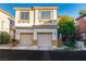 Two-story home featuring a two-car garage and stucco exterior with decorative accents at 10852 Avenzano St, Las Vegas, NV 89141