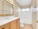 Bright bathroom featuring a wooden vanity, white countertops, and a shower-tub combo at 1716 Battle Creek Cir, Las Vegas, NV 89108