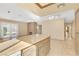 Open living area with tile floors, a brick fireplace, and a laminate counter height kitchen bar at 1716 Battle Creek Cir, Las Vegas, NV 89108