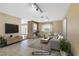 Staged living room featuring a brick fireplace, neutral tones and tile flooring at 1716 Battle Creek Cir, Las Vegas, NV 89108