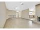 Open-concept living area with a brick fireplace and tile flooring throughout the space at 1716 Battle Creek Cir, Las Vegas, NV 89108